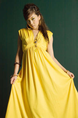 Beautiful sexy Asian woman in yellow dressの写真素材