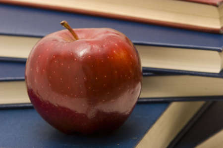 Stack of school books and apple