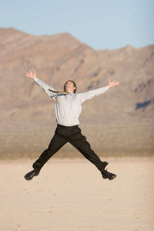 Happy businessman jumping in airの写真素材
