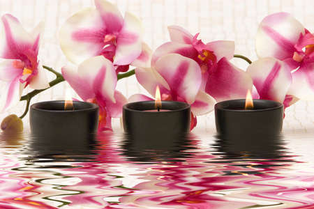 Aromatherapy candles and pink orchidの写真素材