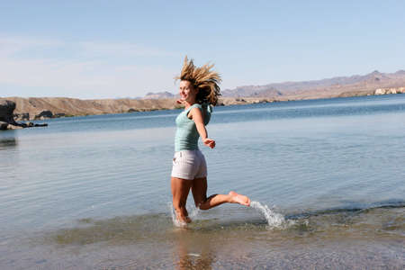 Woman running on the beachの写真素材