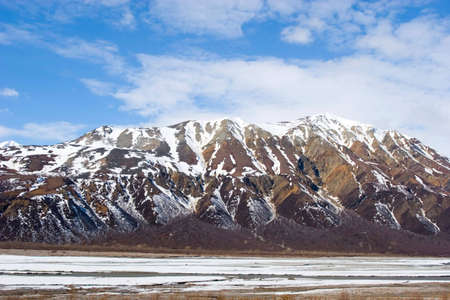Snow melting on mountains in Alaskaの写真素材