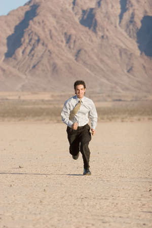 Young businessman running for successの写真素材