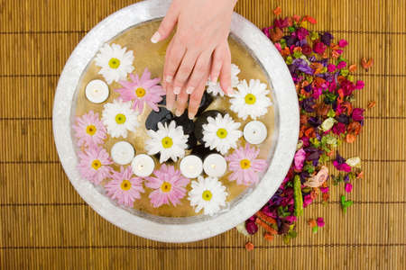 Woman dipping her hand in waterの写真素材
