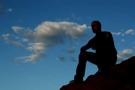 Silhouette of a man on mountain topの写真素材