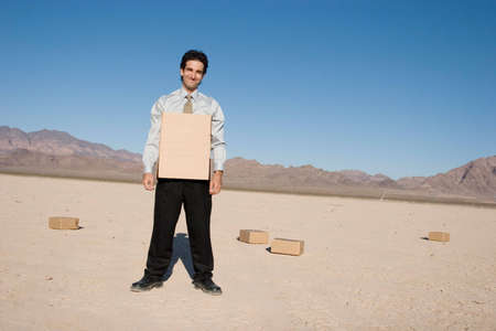 Businessman getting into a cardboard boxの写真素材