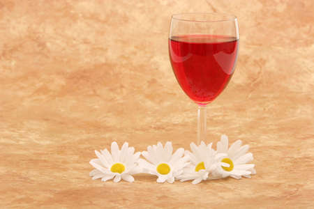 Red wine and white daisiesの写真素材