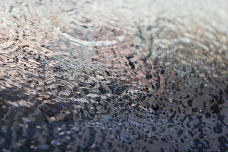 Water pouring over glassの写真素材