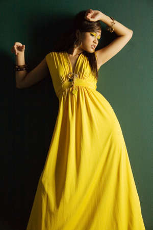 Fashionable pretty woman in yellow dressの写真素材
