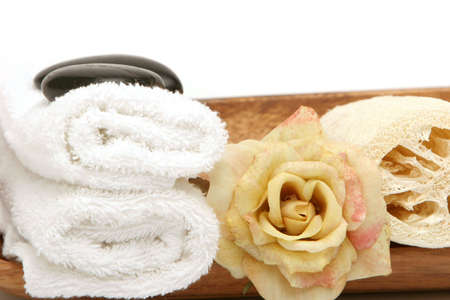 Stack of spa or bath towels and rose