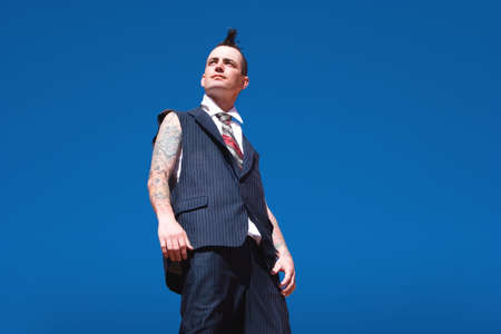 Man with mohawk style haircut and alternative fashion outfitの写真素材