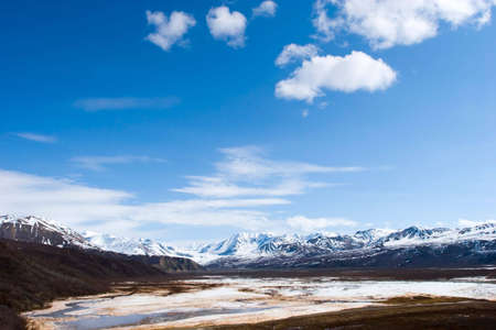 Snow melting on mountains in Alaskaの写真素材