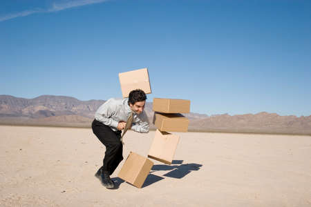 Businessman kicking boxes in the airの写真素材