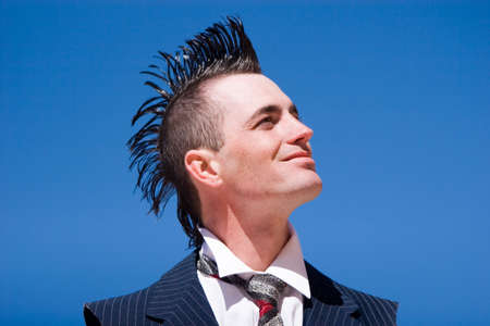 Man with mohawk style haircut and alternative fashion outfit