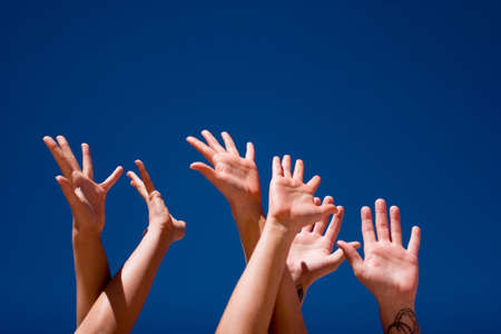 Group of people hands in the airの写真素材