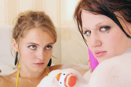 Two beautiful sexy women taking bubble bath togetherの写真素材