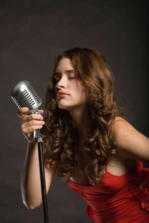 Beautiful sexy young woman singingの写真素材