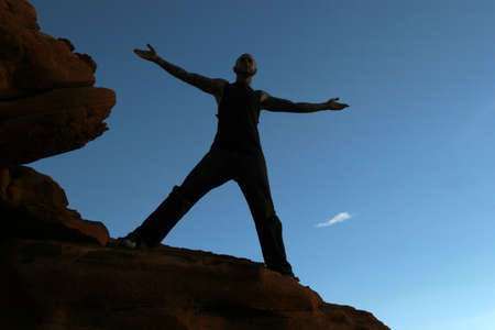 Silhouette of a man on mountain topの写真素材