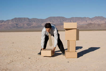 Businessman organizing cardboard shipping boxesの写真素材