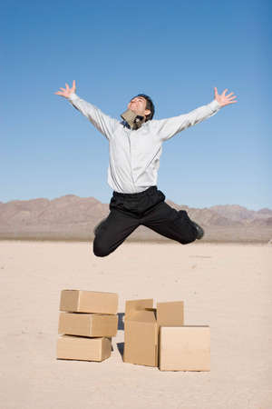 Businessman jumping over the boxesの写真素材