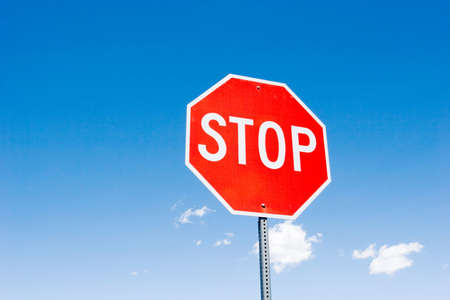 Stop sign for traffic against blue skyの写真素材
