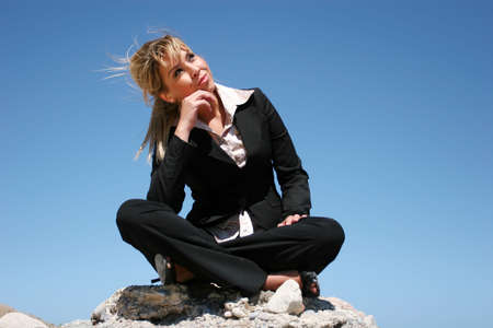 Young businesswoman outdoor against blue skyの写真素材