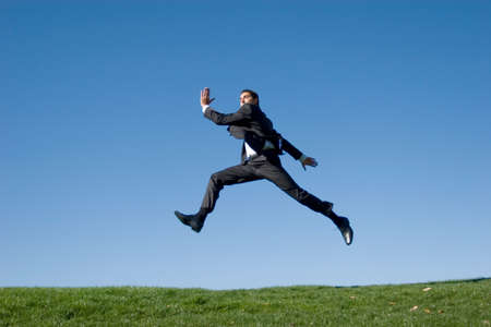 Businessman jumping in the airの写真素材