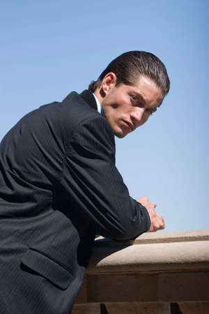 Handsome businessman in dark suitの写真素材