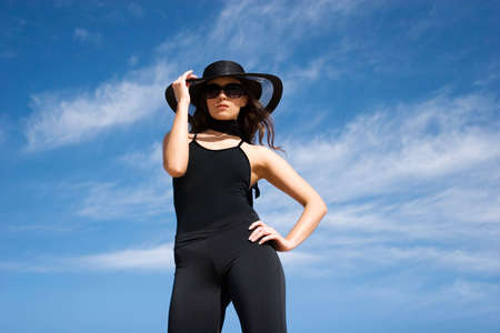 Sexy fashion model wearing hat and sunglasses