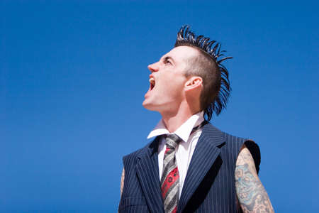 Man with mohawk style haircut and alternative fashion outfitの写真素材