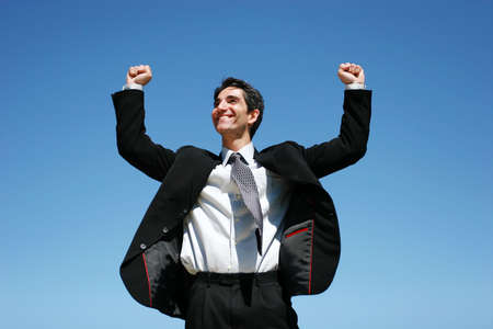 Successful businessman jumping to celebrateの写真素材
