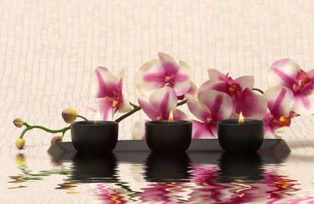 Aromatherapy candles and pink orchidの写真素材