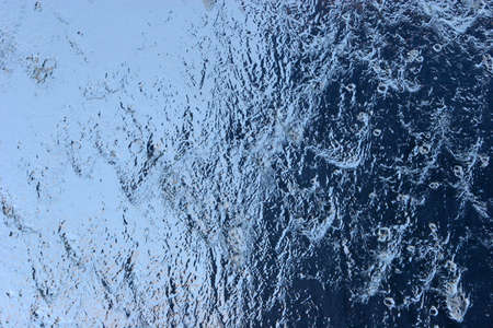 Water pouring over glassの写真素材