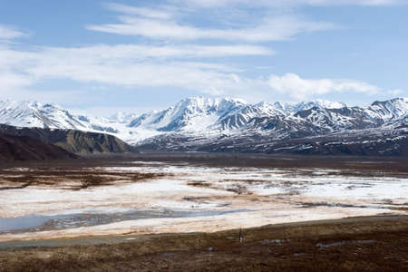 Snow melting on mountains in Alaskaの写真素材