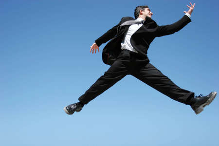 Successful businessman jumping to celebrate