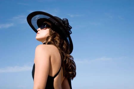Sexy fashion model wearing hat and sunglasses