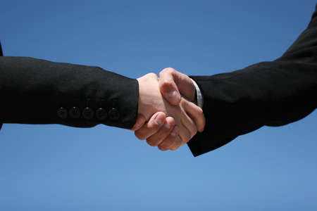 Young girl and guy handshaking for businessの写真素材