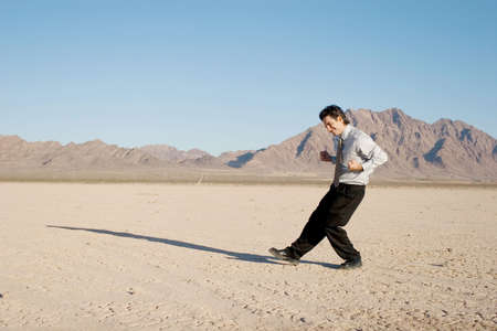 Happy businessman in the desertの写真素材