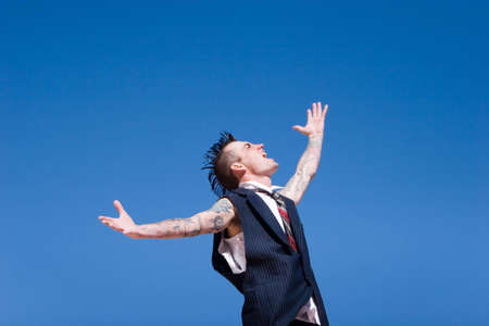 Man with mohawk style haircut and alternative fashion outfitの写真素材