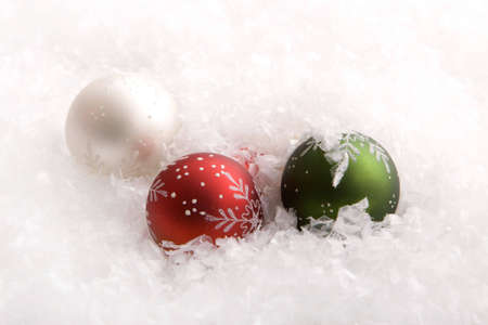 Beautiful colorful Christmas ornaments in snowの写真素材