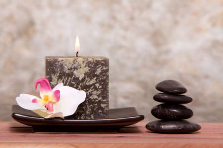 Spa candle and balanced stones with orchidの写真素材