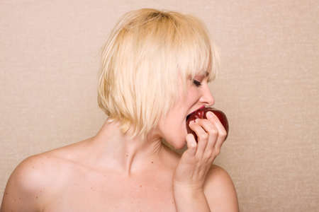 Woman eating a red appleの写真素材