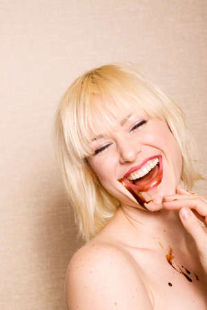 Woman eating chocolate sauceの写真素材