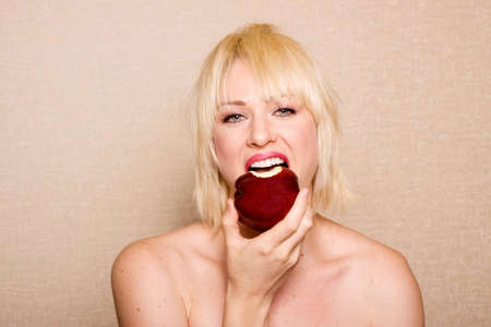 Woman eating a red apple