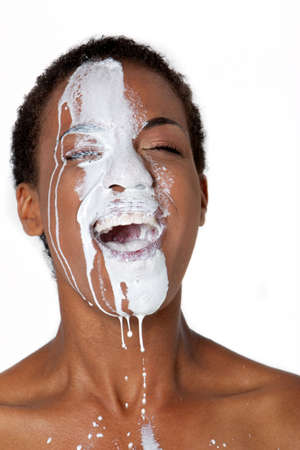 African American woman with milk on her faceの写真素材