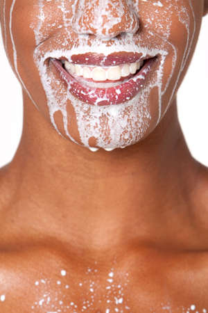African American woman with milk on her faceの写真素材