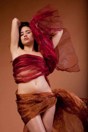 Beautiful sexy young woman in silk fabricの写真素材