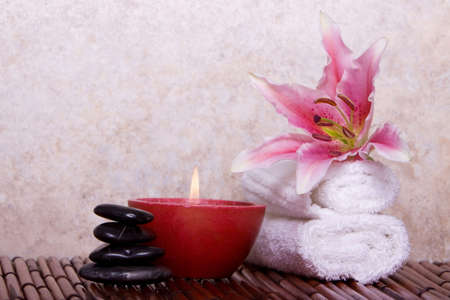 Spa towel, candle and massage stonesの写真素材