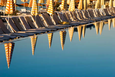 Umbrella reflections in resort swimming poolの写真素材