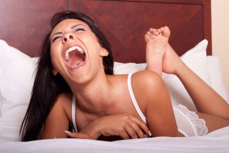 Sexy woman in lingerie lying on bedの写真素材